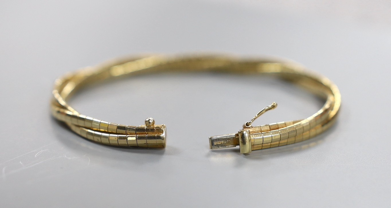 A modern three colour 9ct gold triple strand interwoven bracelet, 17cm, 15.3 grams.
